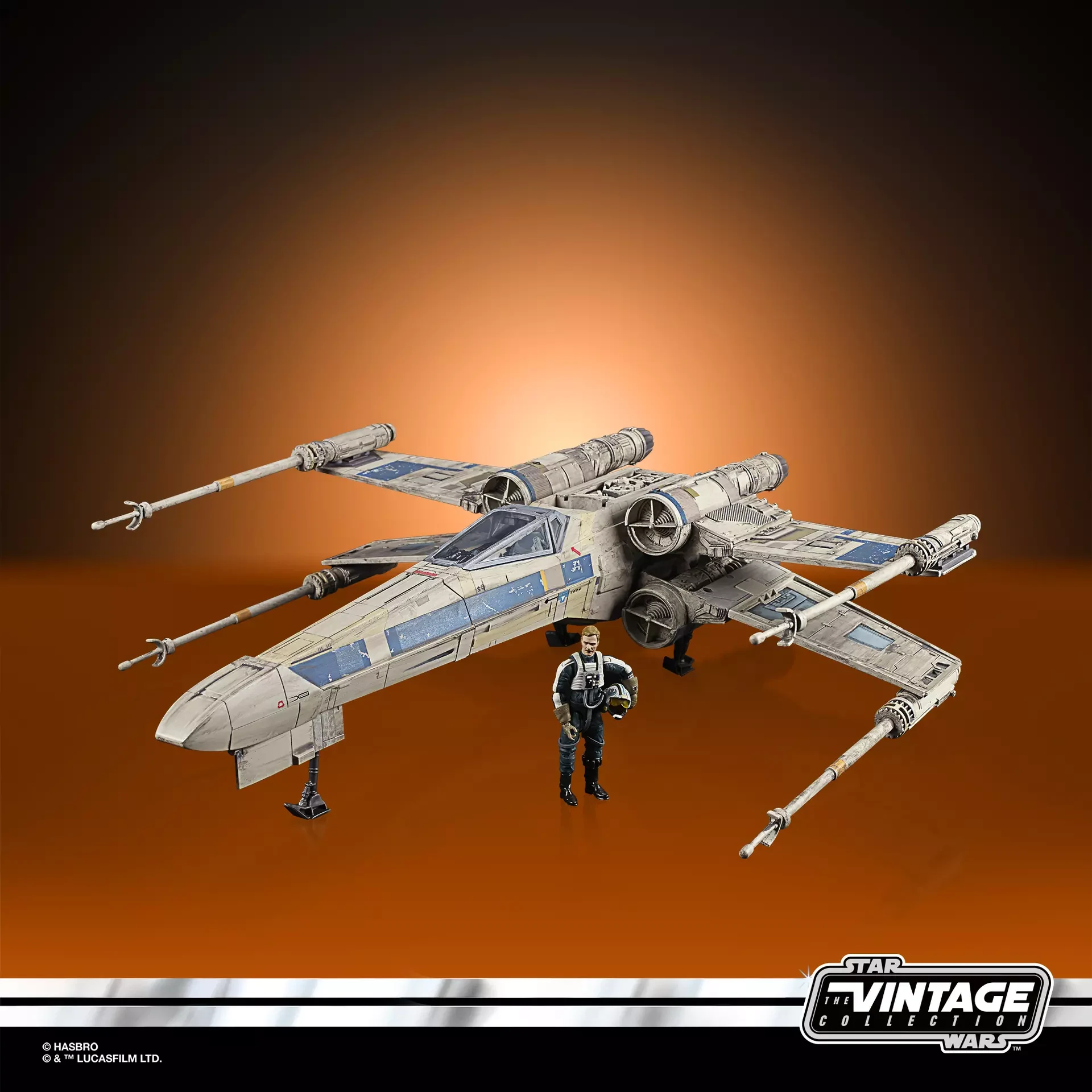 Antoc Merrick action figure without his helmet displayed beside his blue and gray X-Wing Fighter